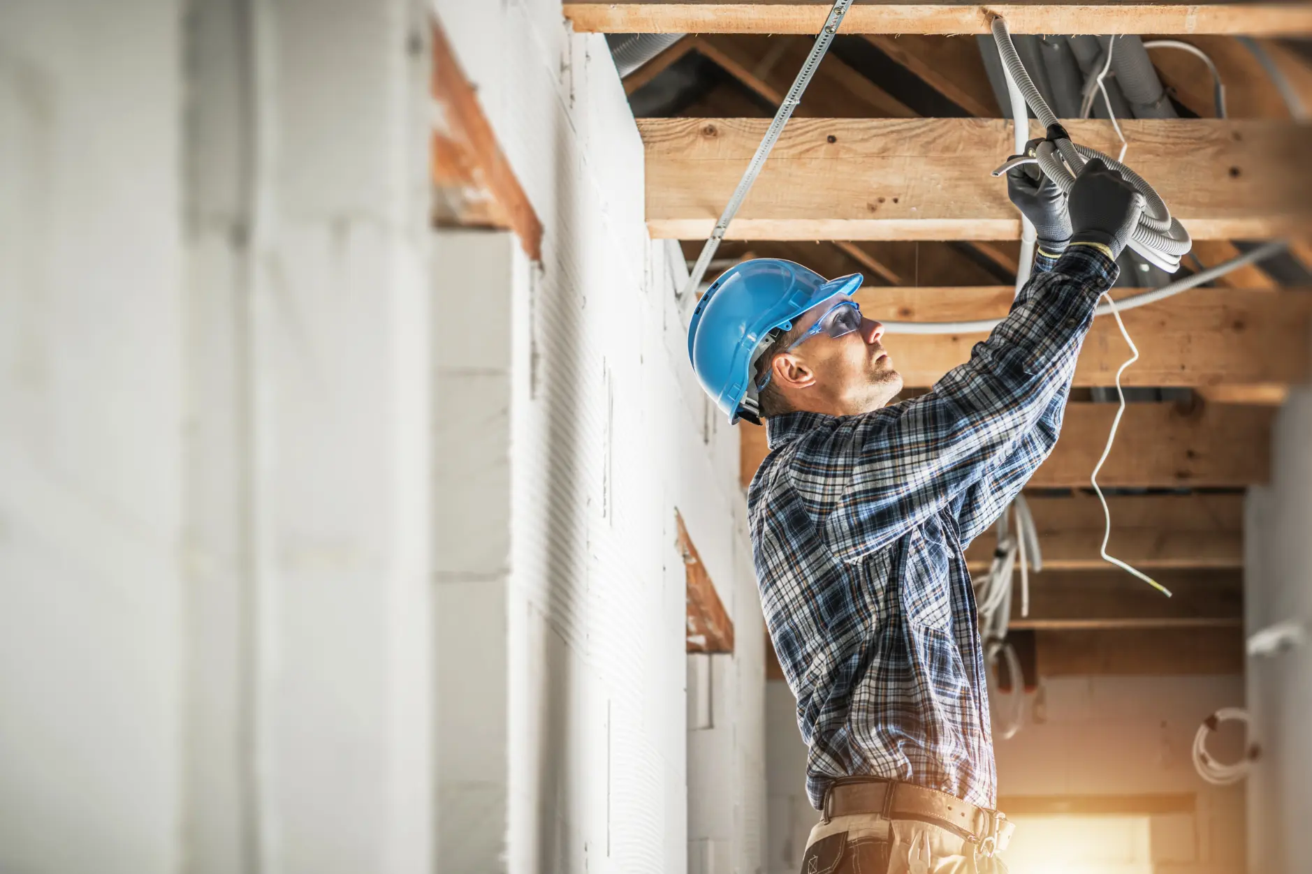Electrician working on wiring in a property